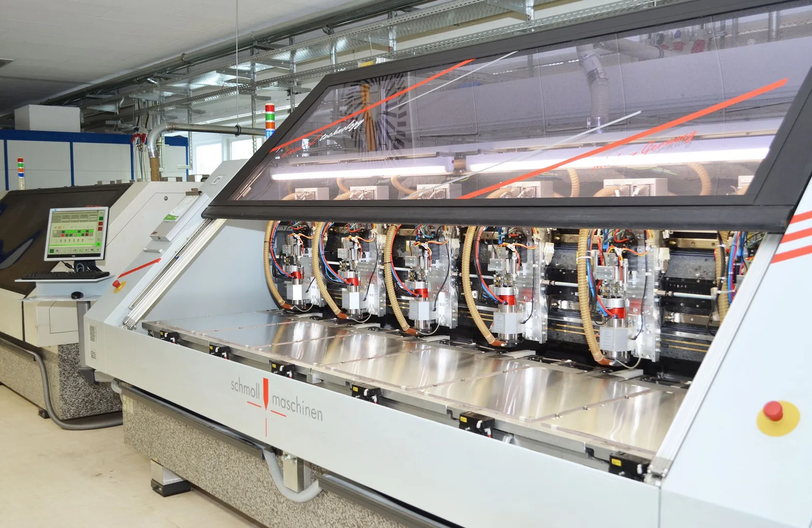 Mehrspindel-Bohrmaschine mit geöffneter Haube in der Produktionshalle